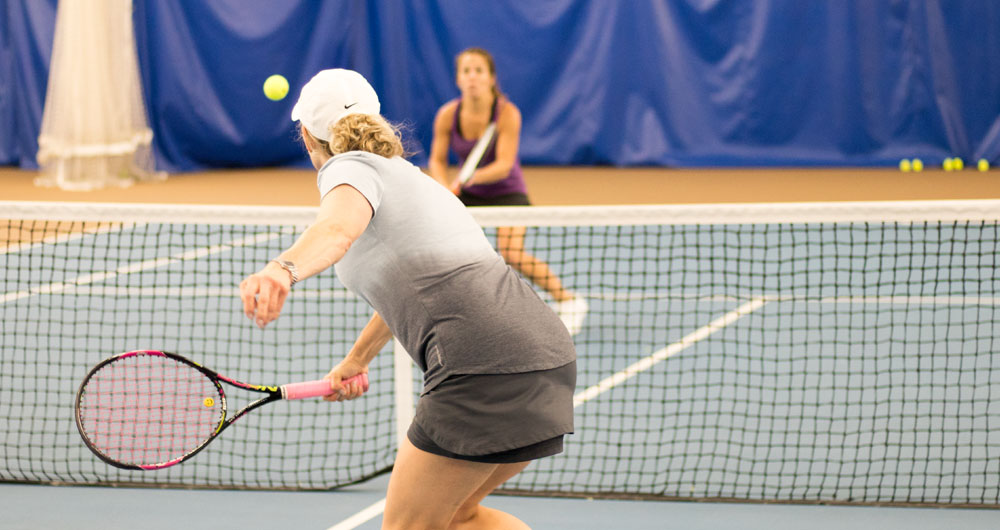 Adults playing tennis